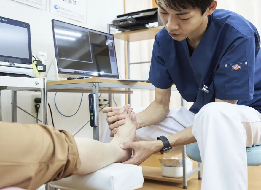 施術者が足首の動きを確認している様子